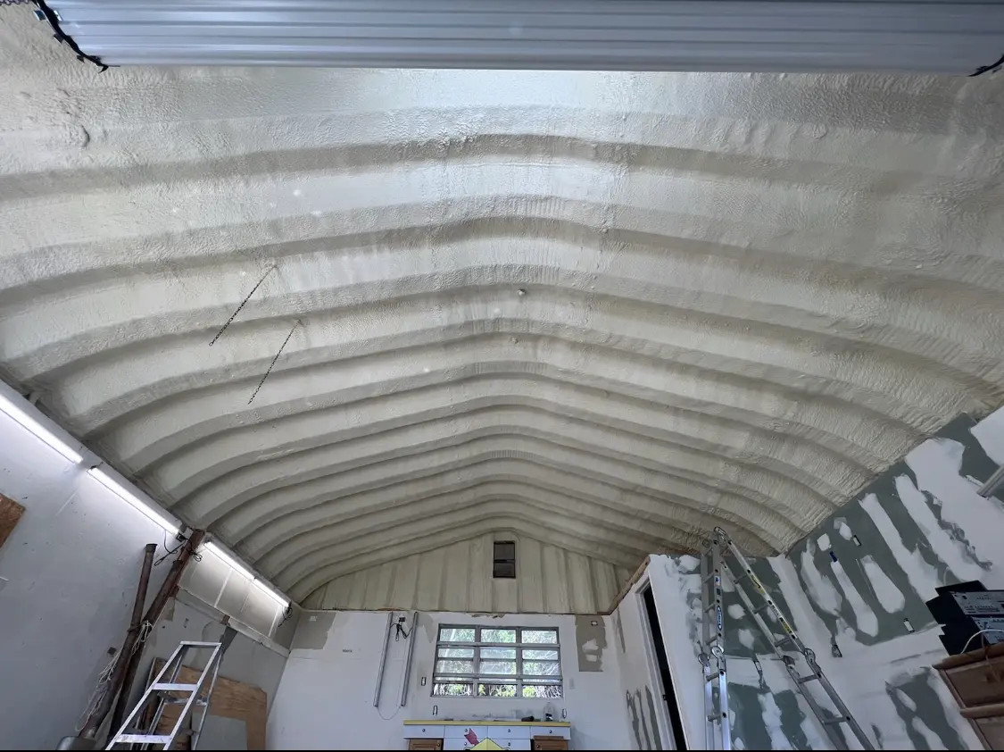 Spray polyurethane foam applied to the underside of a metal roof deck in Minden
